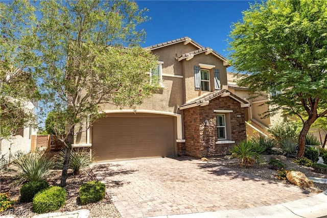 10474 Palmadora St, Las Vegas, NV 89178 - view of front of home with stone siding, stucco siding, a garage, and decorative driveway