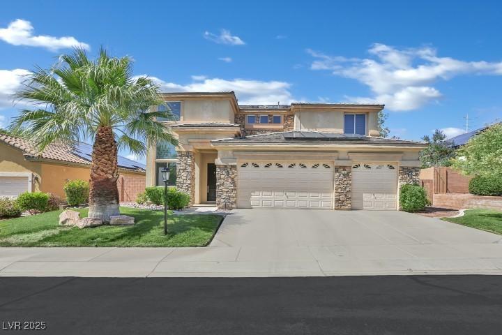 2382 Sunburst View St, Henderson, NV 89052 - view of front of house with stone siding, driveway, and stucco siding