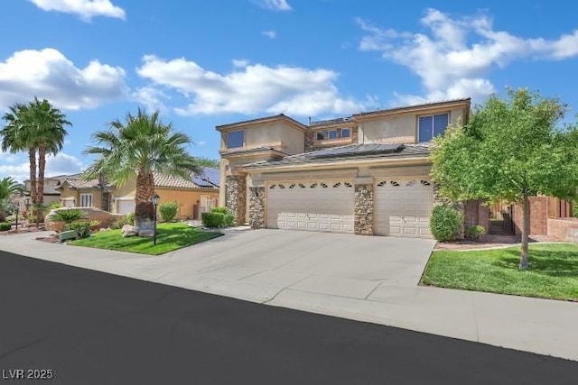 2382 Sunburst View St, Henderson, NV 89052 - view of front of home featuring concrete driveway, roof mounted solar panels, stucco siding, stone siding, and an attached garage