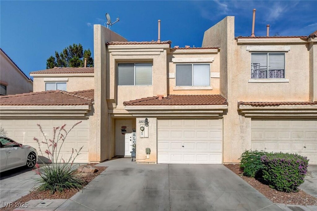 3322 Dragon Fly St, North Las Vegas, NV 89032 - multi unit property with driveway, stucco siding, a tile roof, and an attached garage