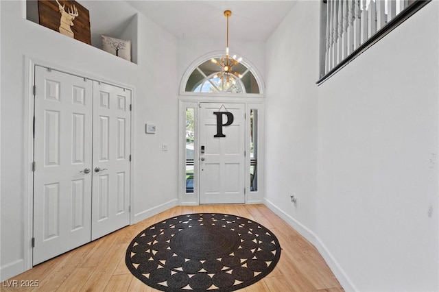 15 Pheasant Ridge Dr, Henderson, NV 89014 - foyer featuring light wood-style floors, a chandelier, baseboards, and a high ceiling