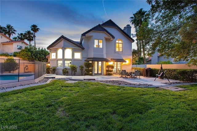 15 Pheasant Ridge Dr, Henderson, NV 89014 - back of house featuring stucco siding, a patio area, and a chimney