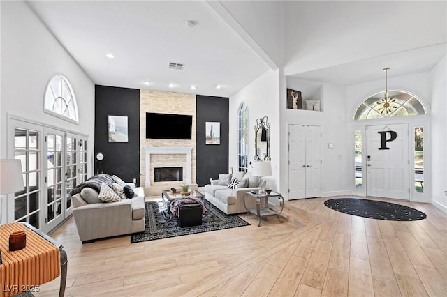 15 Pheasant Ridge Dr, Henderson, NV 89014 - living room featuring a towering ceiling, plenty of natural light, wood finished floors, a stone fireplace, and recessed lighting