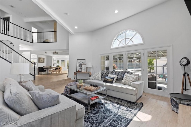 15 Pheasant Ridge Dr, Henderson, NV 89014 - living room with high vaulted ceiling, wood finished floors, stairs, and french doors