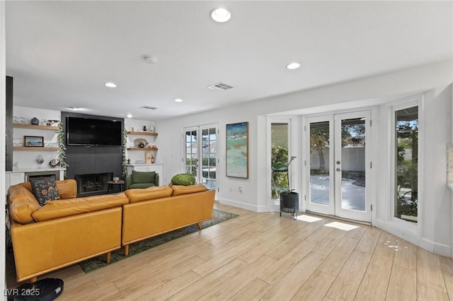 15 Pheasant Ridge Dr, Henderson, NV 89014 - living room featuring a large fireplace, light wood-style flooring, french doors, baseboards, and recessed lighting