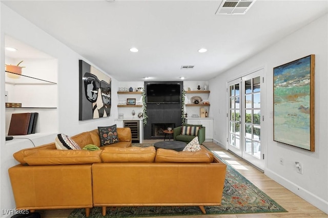 15 Pheasant Ridge Dr, Henderson, NV 89014 - living area with light wood-style flooring, baseboards, beverage cooler, recessed lighting, and a fireplace