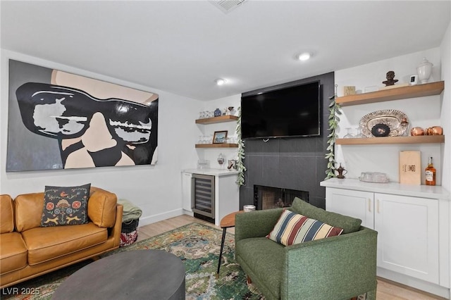 15 Pheasant Ridge Dr, Henderson, NV 89014 - living area featuring wine cooler, light wood finished floors, baseboards, and a fireplace