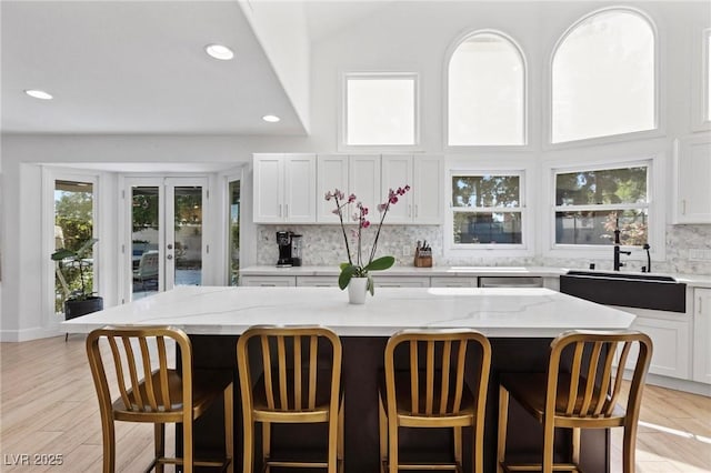 15 Pheasant Ridge Dr, Henderson, NV 89014 - kitchen with a sink, decorative backsplash, a kitchen bar, recessed lighting, and a kitchen island