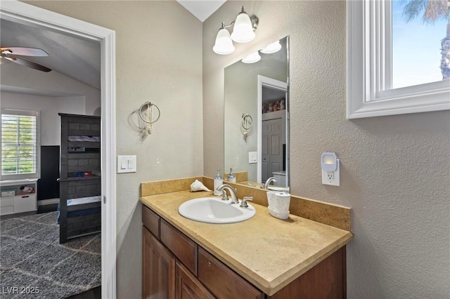 15 Pheasant Ridge Dr, Henderson, NV 89014 - bathroom with ceiling fan, vanity, a textured wall, and lofted ceiling