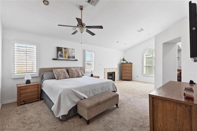 15 Pheasant Ridge Dr, Henderson, NV 89014 - bedroom with vaulted ceiling, light colored carpet, baseboards, and a glass covered fireplace