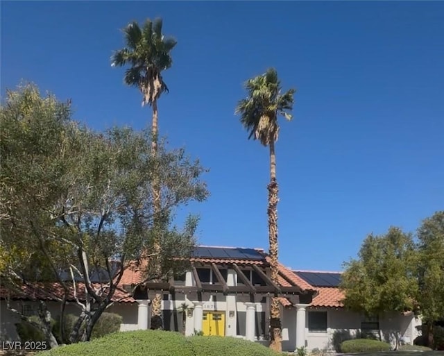 1871 Ski Slope Cir, Las Vegas, NV 89117 - view of front of home with roof mounted solar panels, stucco siding, and a tiled roof