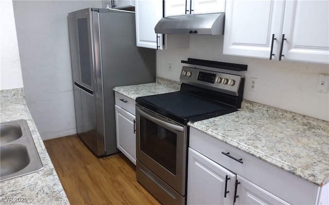 3441 Villa Way, Las Vegas, NV 89120 - kitchen featuring appliances with stainless steel finishes, under cabinet range hood, light wood-type flooring, and white cabinetry