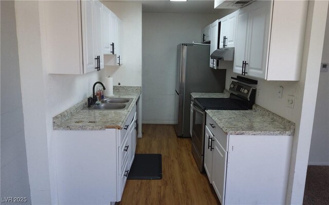3441 Villa Way, Las Vegas, NV 89120 - kitchen featuring stainless steel range with electric cooktop, wood finished floors, ventilation hood, white cabinetry, and light countertops