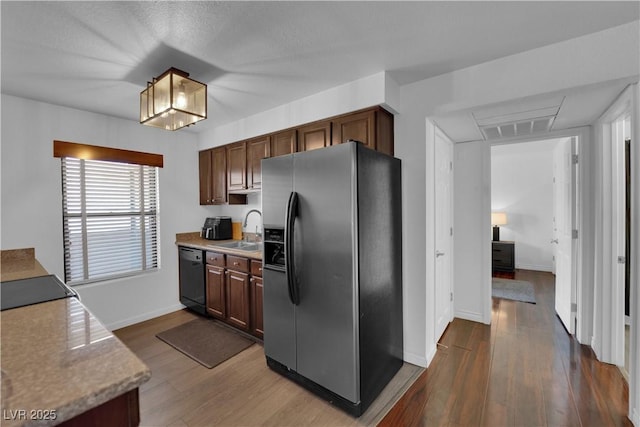 2451 N Rainbow Blvd Unit 2043, Las Vegas, NV 89108 - kitchen with stainless steel fridge, dishwasher, dark wood-type flooring, and light countertops