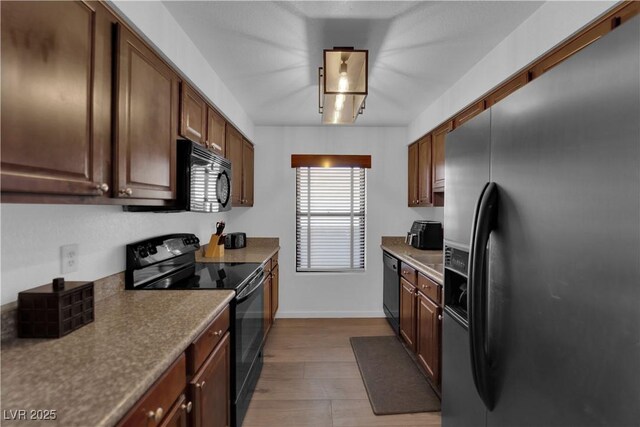 2451 N Rainbow Blvd Unit 2043, Las Vegas, NV 89108 - kitchen featuring black appliances and wood finished floors