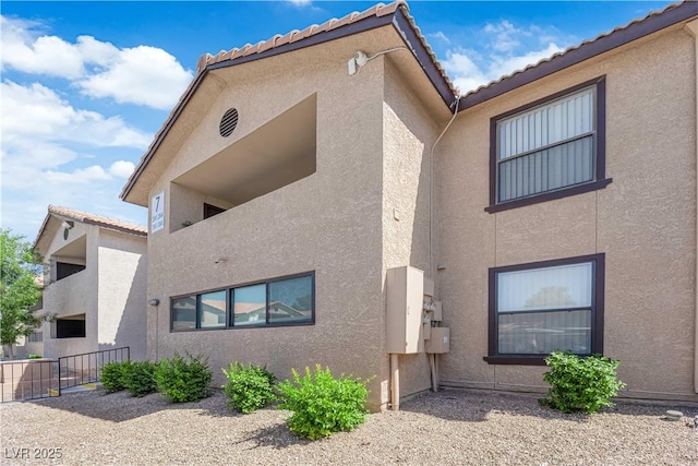 2451 N Rainbow Blvd Unit 2043, Las Vegas, NV 89108 - view of side of property with stucco siding and a tiled roof