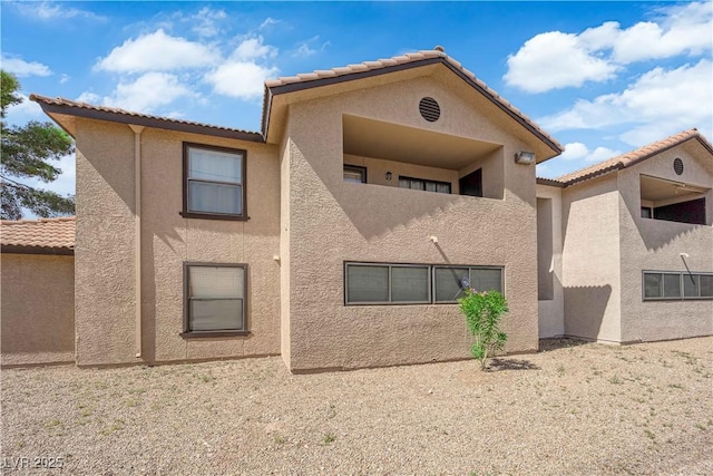 2451 N Rainbow Blvd Unit 2043, Las Vegas, NV 89108 - rear view of house with stucco siding and a tiled roof