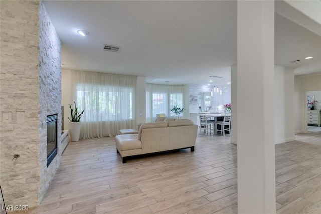 8221 Bay Dunes St, Las Vegas, NV 89131 - living area featuring light wood-style floors and a fireplace