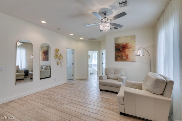 8221 Bay Dunes St, Las Vegas, NV 89131 - living area featuring a ceiling fan, recessed lighting, light wood-style flooring, baseboards, and arched walkways