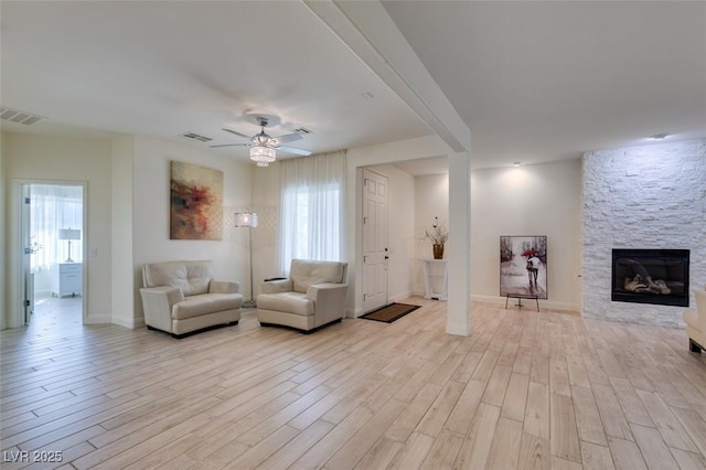 8221 Bay Dunes St, Las Vegas, NV 89131 - living area featuring wood finished floors, ceiling fan, a fireplace, and baseboards