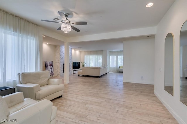 8221 Bay Dunes St, Las Vegas, NV 89131 - living room featuring ceiling fan, light wood finished floors, arched walkways, baseboards, and recessed lighting