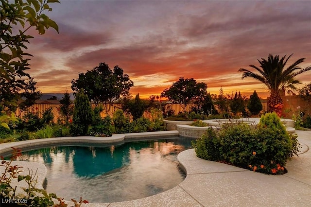 8221 Bay Dunes St, Las Vegas, NV 89131 - pool at dusk featuring a fenced backyard