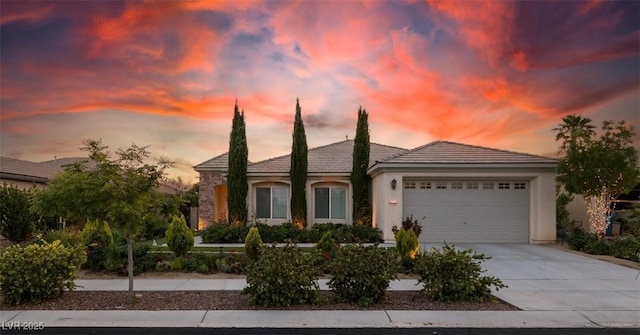8221 Bay Dunes St, Las Vegas, NV 89131 - view of front facade with a garage, driveway, stucco siding, and a tiled roof