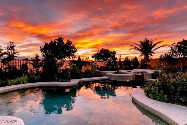 8221 Bay Dunes St, Las Vegas, NV 89131 - pool at dusk with a fenced backyard and a pool with connected hot tub