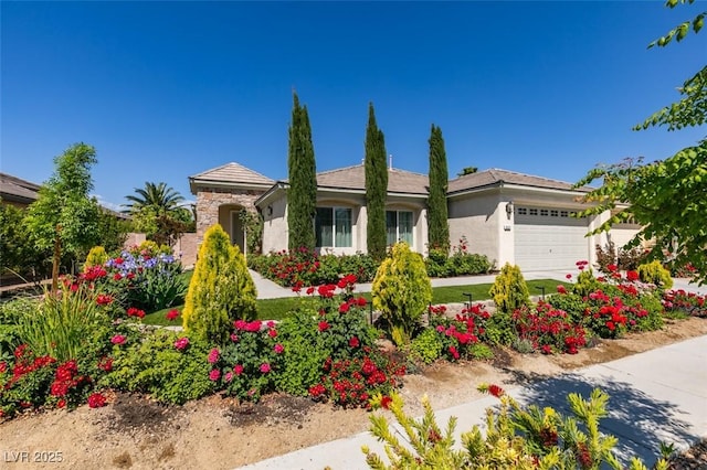 8221 Bay Dunes St, Las Vegas, NV 89131 - view of front of house with a garage, stucco siding, and stone siding