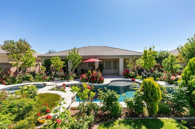 8221 Bay Dunes St, Las Vegas, NV 89131 - back of house with an outdoor pool and a patio area