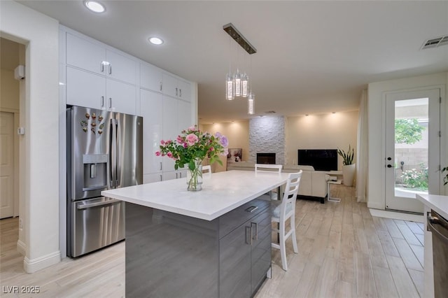 8221 Bay Dunes St, Las Vegas, NV 89131 - kitchen featuring appliances with stainless steel finishes, light wood-style flooring, white cabinets, light countertops, and recessed lighting