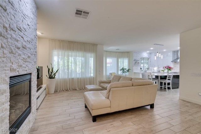 8221 Bay Dunes St, Las Vegas, NV 89131 - living room with light wood finished floors and a fireplace