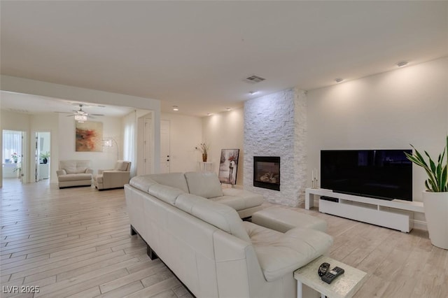 8221 Bay Dunes St, Las Vegas, NV 89131 - living room featuring light wood-style flooring, a fireplace, and a ceiling fan