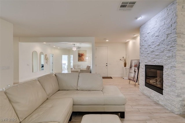 8221 Bay Dunes St, Las Vegas, NV 89131 - living area with light wood-type flooring, a ceiling fan, a fireplace, and recessed lighting