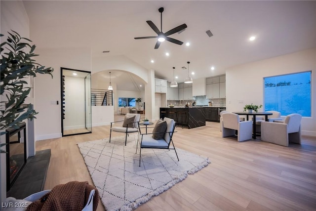 8104 Bay Harbor Dr, Las Vegas, NV 89128 - living area with light wood-type flooring, a ceiling fan, vaulted ceiling, recessed lighting, and arched walkways