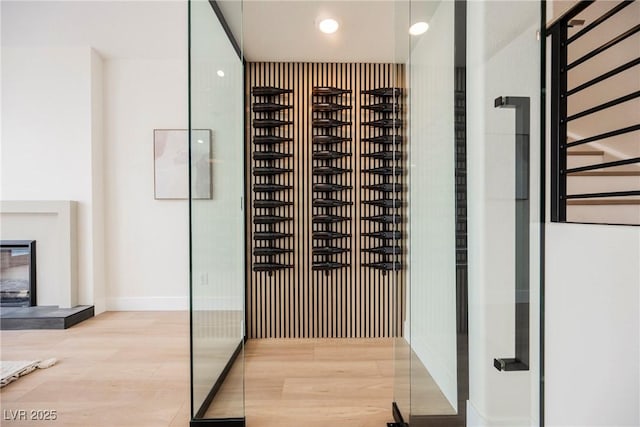 8104 Bay Harbor Dr, Las Vegas, NV 89128 - wine cellar featuring wood finished floors, a glass covered fireplace, baseboards, and recessed lighting