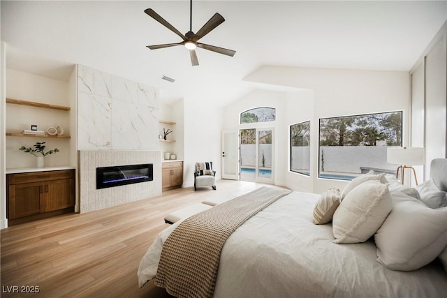 8104 Bay Harbor Dr, Las Vegas, NV 89128 - bedroom with access to exterior, a fireplace, light wood-style flooring, high vaulted ceiling, and a ceiling fan