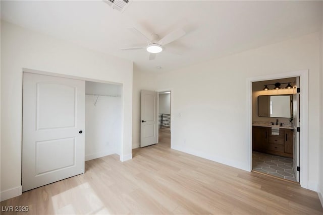 8104 Bay Harbor Dr, Las Vegas, NV 89128 - unfurnished bedroom with light wood-type flooring, a closet, baseboards, ensuite bathroom, and ceiling fan