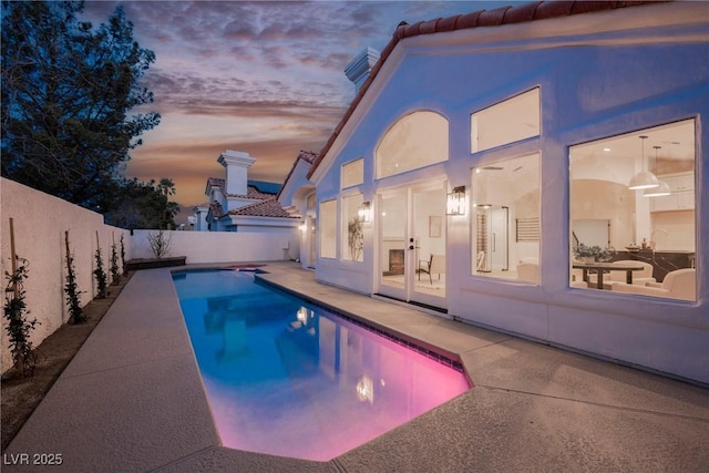 8104 Bay Harbor Dr, Las Vegas, NV 89128 - pool at dusk with a patio and a fenced backyard