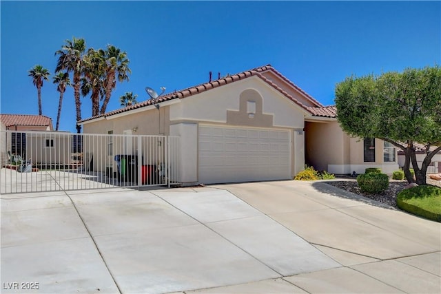 805 Palmero Way, Boulder City, NV 89005 - mediterranean / spanish-style house featuring concrete driveway, a tiled roof, a garage, and stucco siding