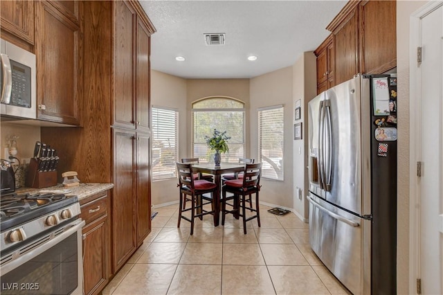 805 Palmero Way, Boulder City, NV 89005 - kitchen featuring stainless steel appliances, brown cabinetry, baseboards, and recessed lighting