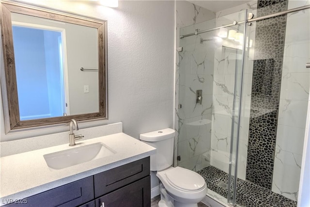 8600 W Charleston Blvd Unit 2068, Las Vegas, NV 89117 - full bath featuring vanity, a marble finish shower, toilet, and a textured wall
