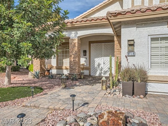 9718 Camino Capistrano Ln, Las Vegas, NV 89147 - view of exterior entry featuring stucco siding and a patio