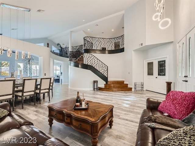 9718 Camino Capistrano Ln, Las Vegas, NV 89147 - living room with high vaulted ceiling, wood finished floors, stairway, and baseboards