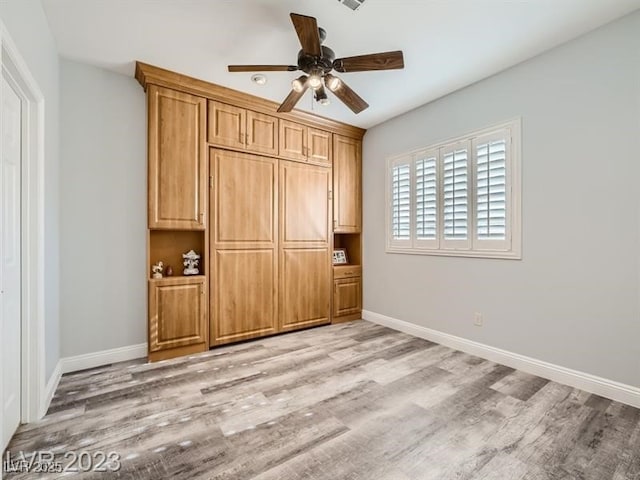 9718 Camino Capistrano Ln, Las Vegas, NV 89147 - unfurnished bedroom featuring light wood-type flooring, baseboards, and a ceiling fan