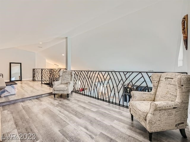 9718 Camino Capistrano Ln, Las Vegas, NV 89147 - living area with wood finished floors, an upstairs landing, baseboards, and vaulted ceiling