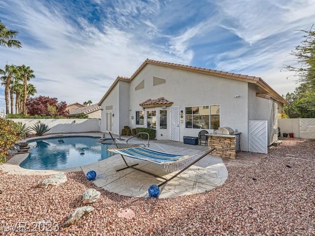 9718 Camino Capistrano Ln, Las Vegas, NV 89147 - view of pool with an outdoor kitchen, a fenced backyard, and a patio