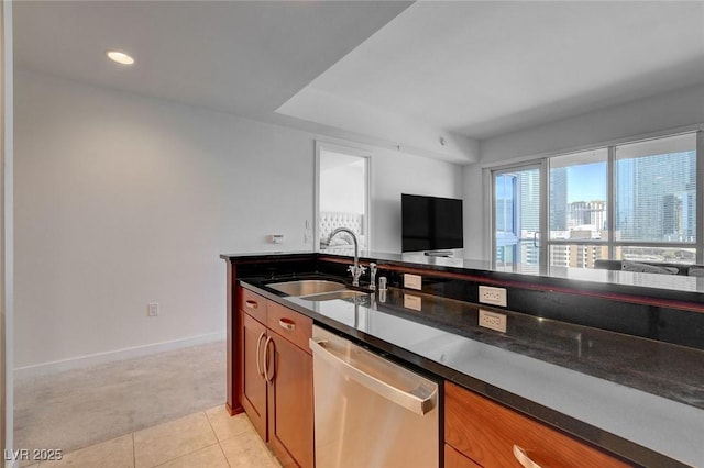 4525 Dean Martin Dr Unit 901, Las Vegas, NV 89103 - kitchen with stainless steel dishwasher, a sink, light carpet, dark countertops, and brown cabinetry