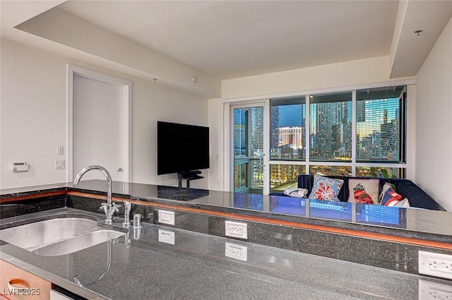 4525 Dean Martin Dr Unit 901, Las Vegas, NV 89103 - kitchen featuring a sink and dark stone countertops