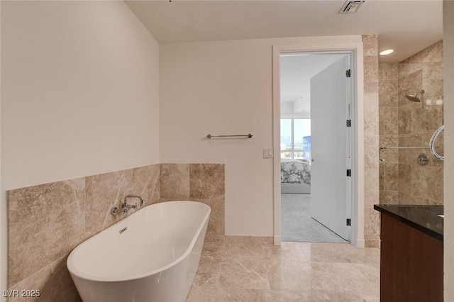 4525 Dean Martin Dr Unit 901, Las Vegas, NV 89103 - ensuite bathroom featuring a soaking tub, vanity, tile walls, and a tile shower